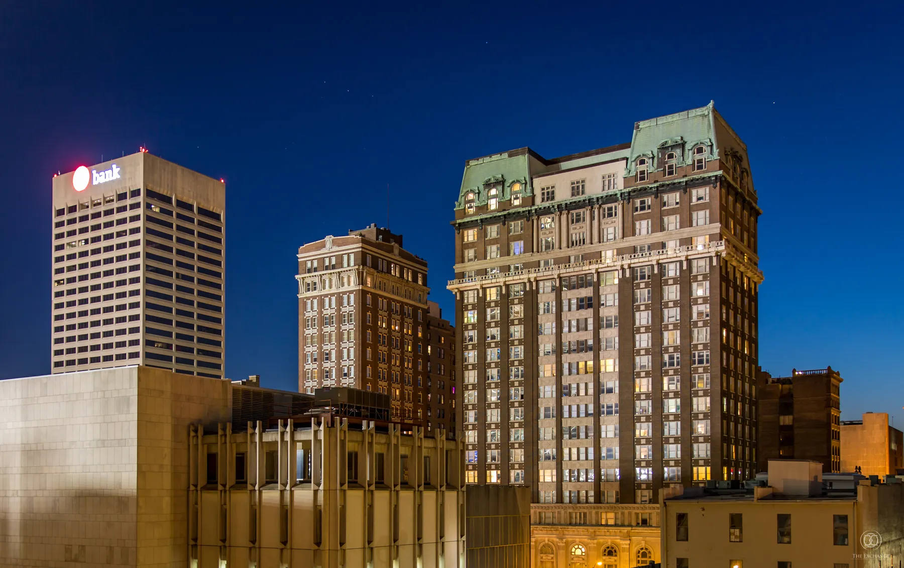 The Exchange Building lit at night against the Downtown Memphis skyline